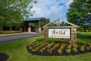 Avila entrance stone and sign with flowers in bloom