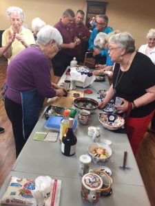 Residents learning how to make sushi from fellow resident at Ávila