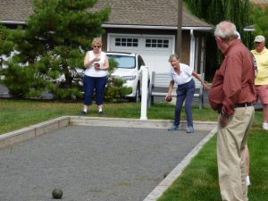 Active seniors playing bocce ball at Avila Retirement Community