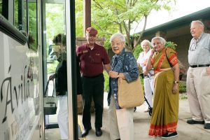 residents smiling as boarding the bus