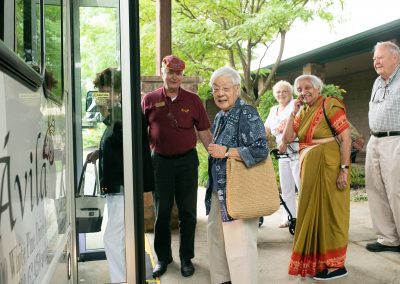 residents smiling as boarding the bus