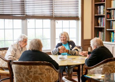 4 ladies playing cards in the library