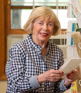 smiling senior buying card at country store