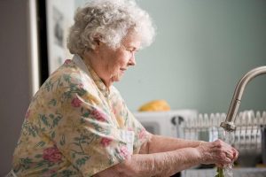 older woman washing hands